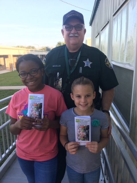 Deputy with two children with KLPB brochures